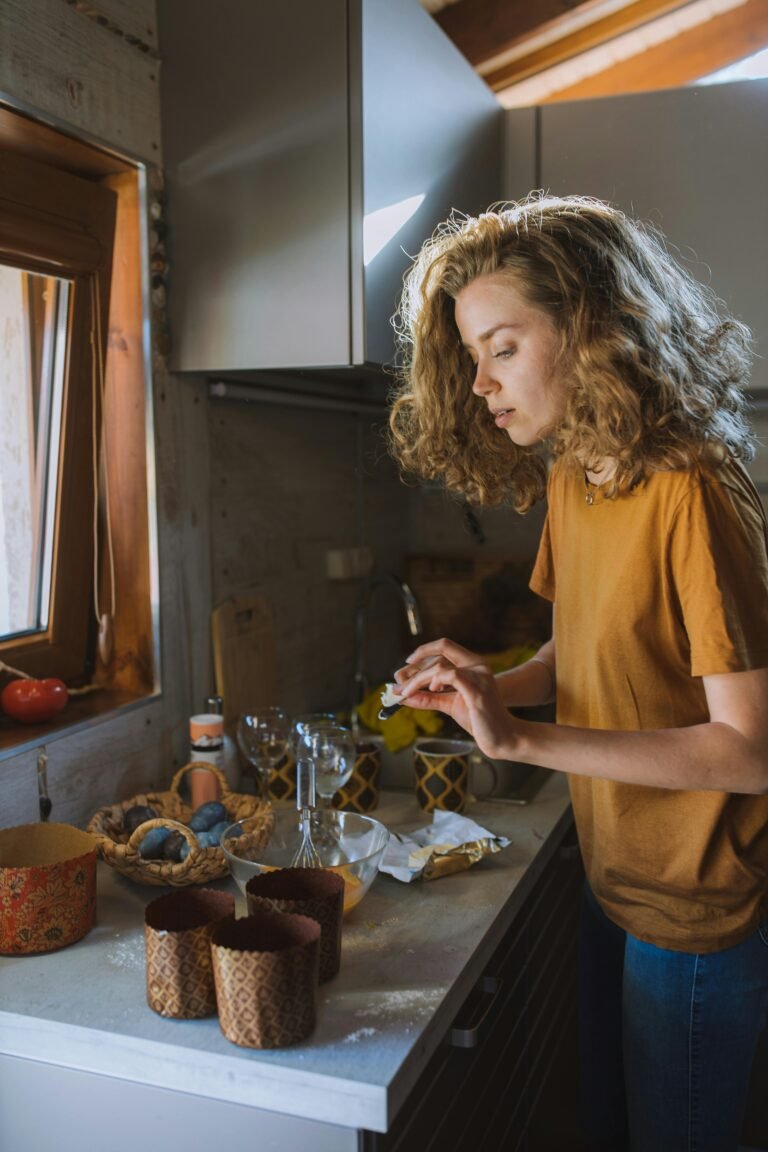 A young woman preparing baked goods on a cozy kitchen countertop.